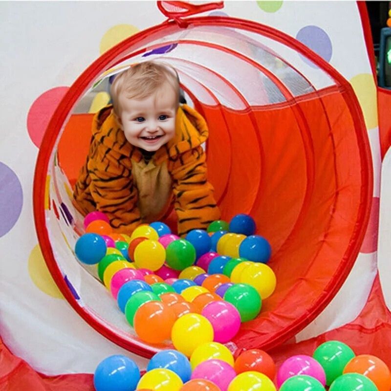 bébé 2 ans heureux dans tunnel de piscine a balle