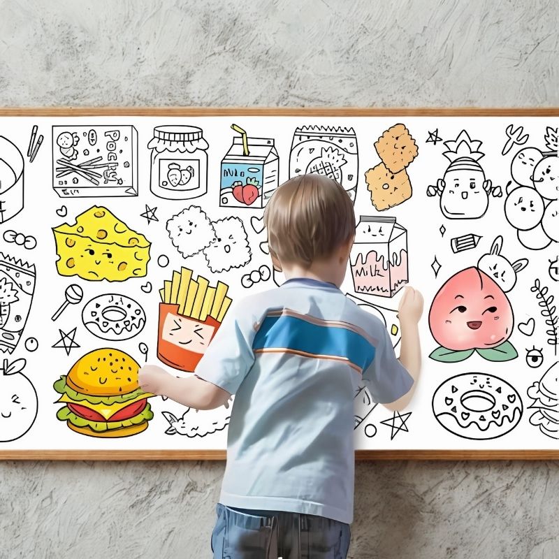 un-jeune-garçon-dessine-sur-une-feuille-géante