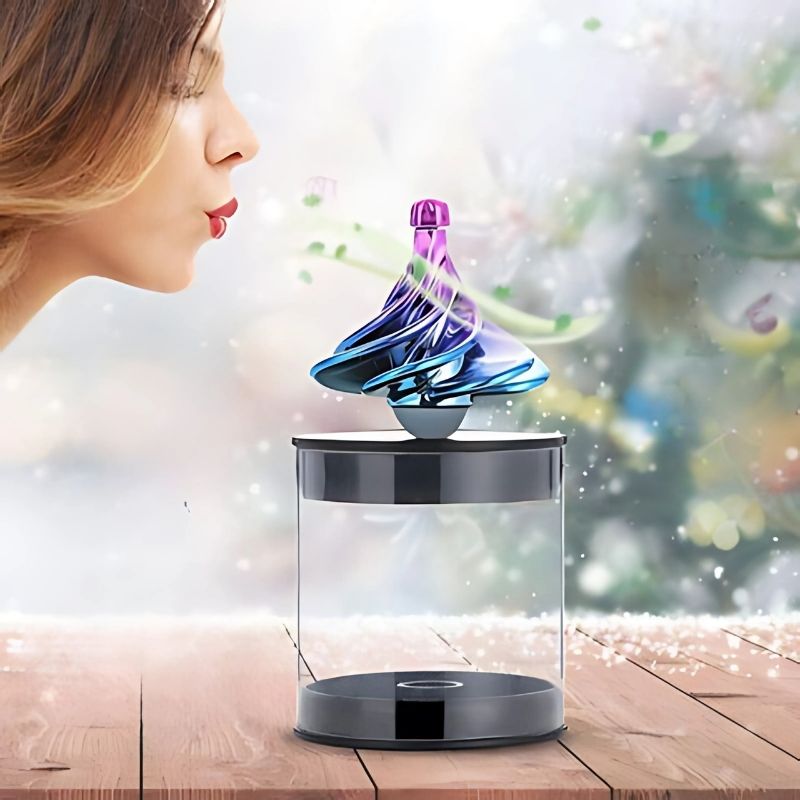 une-femme-souffle-sur-une-toupie-bleue-et-rose